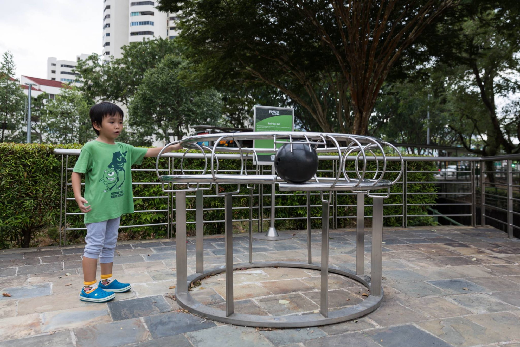 roll up ball outdoor physics exhibit at the singapore science centre kinetic garden with a child looking at the ball